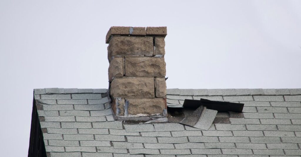 chimney on asphalt shingle roof with poor flashing