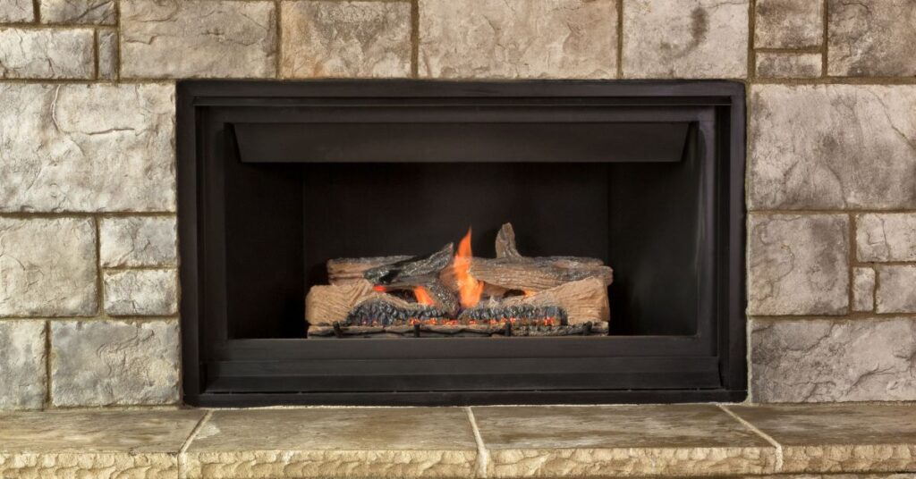 gas log fireplace with stone hearth
