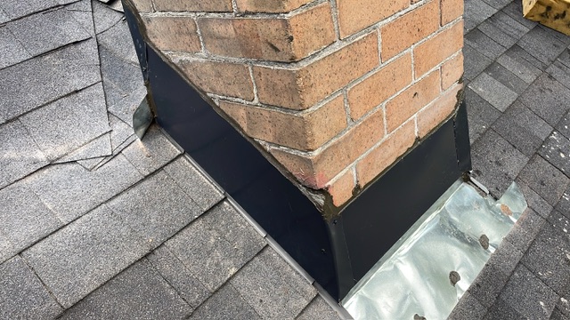 New counterflashing and step flashing wrapped around brick chimney corner